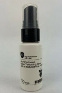 Hair texturizing spray bottle on white background.