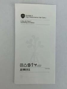 Hair care product packaging with printed text.