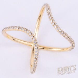 Gold ring with diamond accents, cross design.