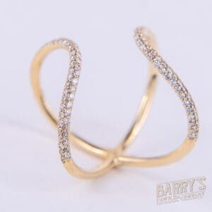 Gold ring with diamond accents, intertwined design.