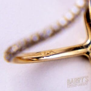 Gold ring with diamond accents, close-up.