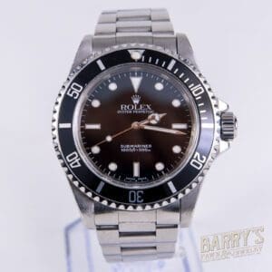 Silver Rolex Submariner watch on display stand.