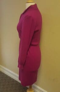 Mannequin wearing a pink dress, side view.