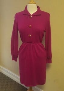 Pink long-sleeve dress on mannequin.