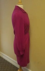 Pink dress on mannequin, side view.