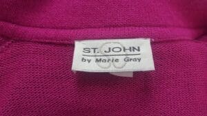 St. John label on pink fabric garment.