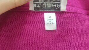 Clothing tag showing size and manufacturing location.