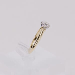 Gold ring with a diamond solitaire.