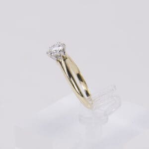 Gold ring with a single diamond stone.