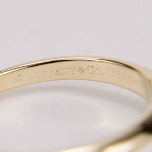 Gold ring with engraved brand inscription.