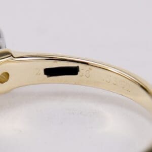 Gold ring with engraved markings inside band.