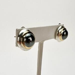 Gold and silver-tone stud earrings display.