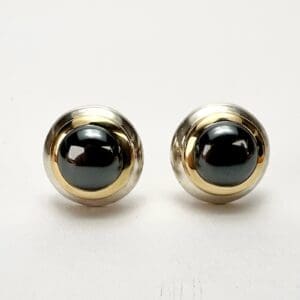 Gold and silver round cufflinks with stones.