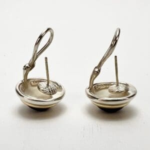 Silver earrings with intricate loop design.