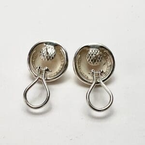 Silver round earrings with textured design.