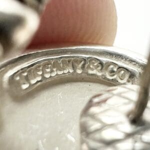 Close-up of engraved silver jewelry piece.
