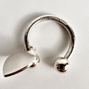 Silver ring with leaf and ball design.