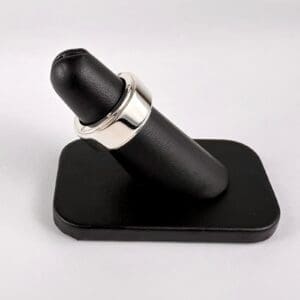 Ring display stand with black cushion.