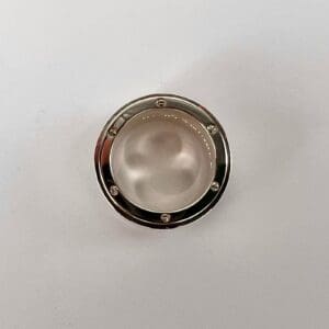 Silver circular object on white background.