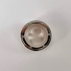 Round metal object with a clear center.