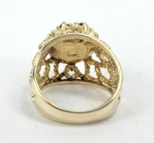 Ornate gold ring with intricate detailing.