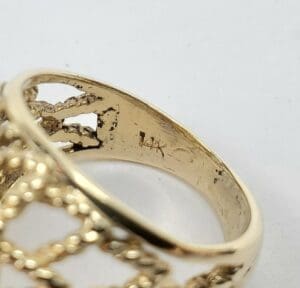 Gold ring with intricate lattice design.