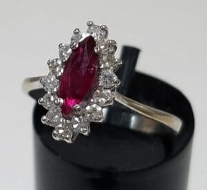 Silver ring with red and white gemstones.