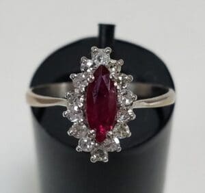 Ruby ring with diamond accents on display.