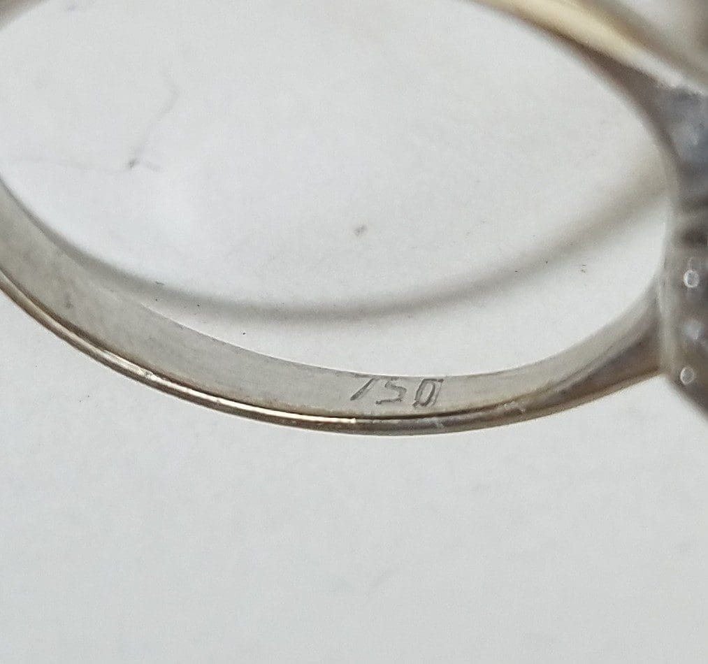Engraving inside a silver ring band.