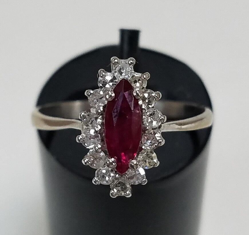 Ruby ring with diamond accents on display.