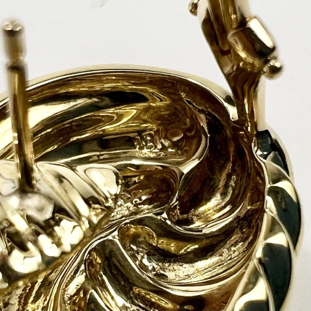 Close-up of a gold earring's back.