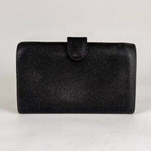 Black textured leather wallet on display.