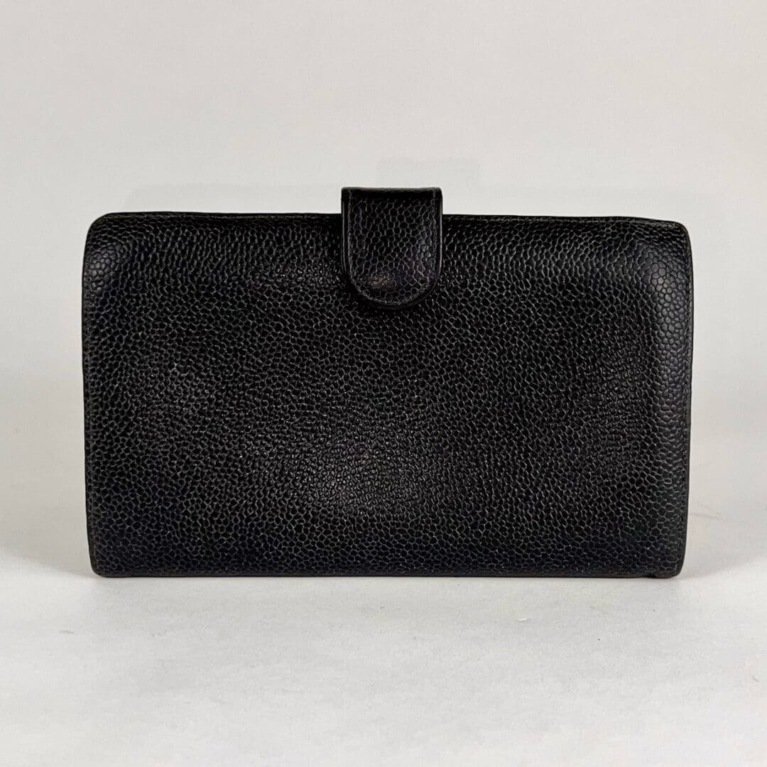 Black textured leather wallet on display.