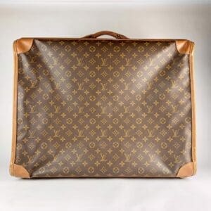 Brown monogram suitcase with leather corners.