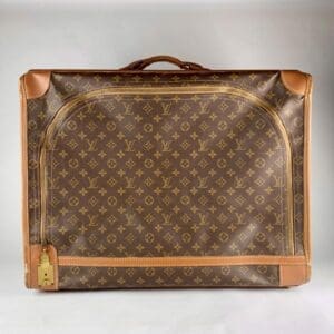 Brown designer suitcase with monogram pattern.