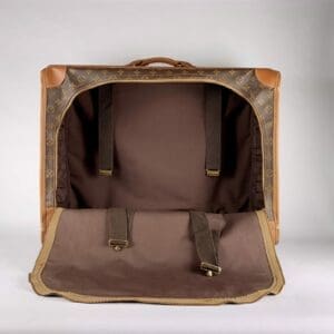 Open vintage suitcase with straps visible.