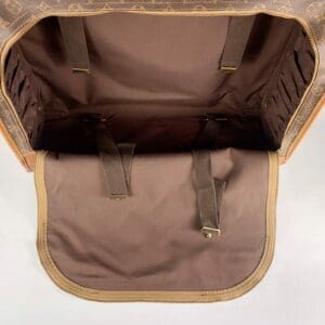 Open brown leather bag interior view.