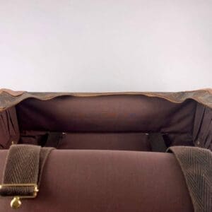 Open brown leather bag, empty interior view.
