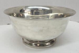 Silver metal bowl on a white surface.