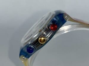 Clear watch with colorful side buttons.