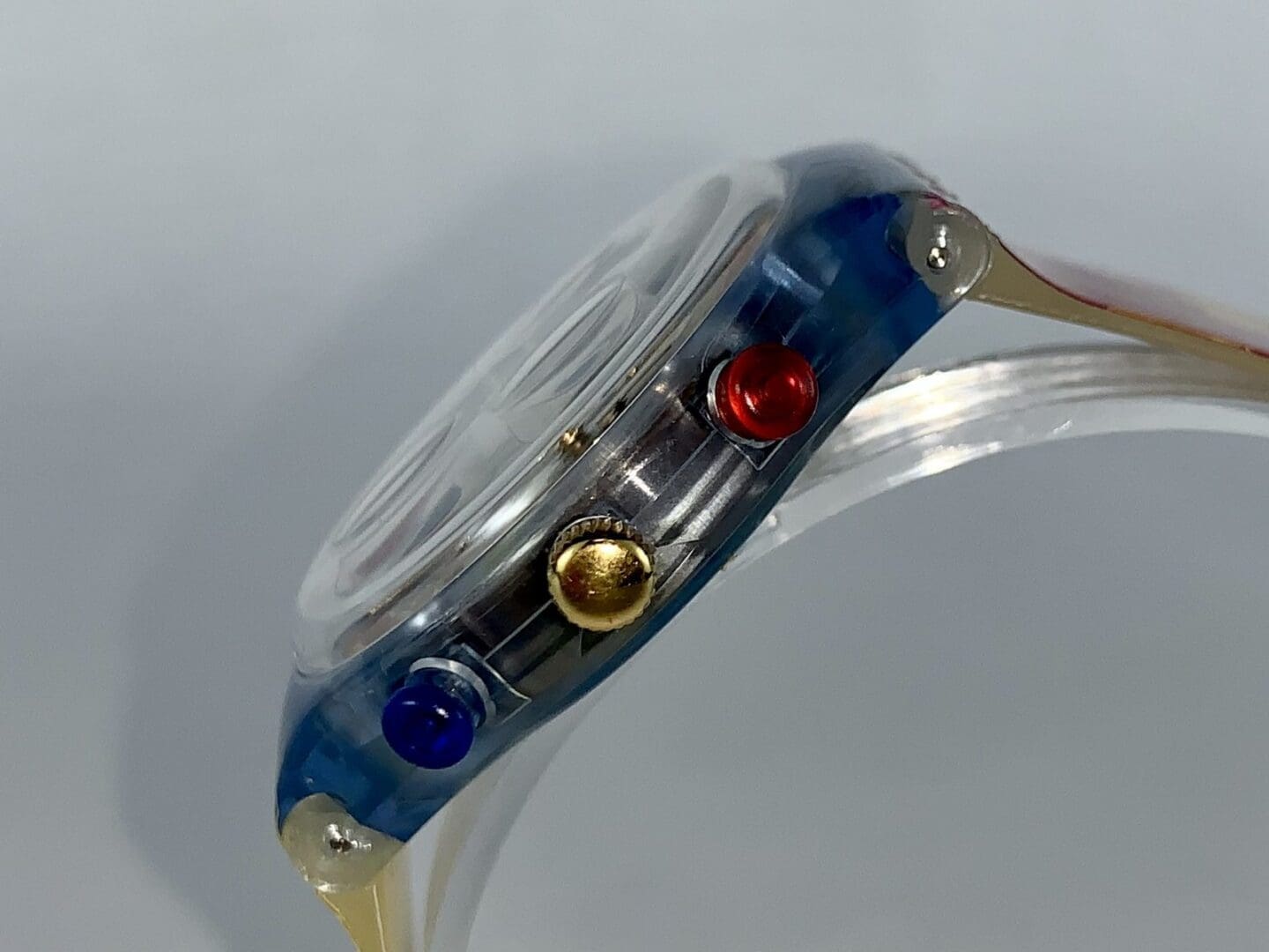 Clear watch with colorful side buttons.