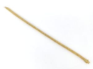 Gold chain bracelet on white background.