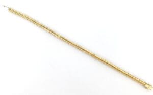 Gold chain bracelet on white background.