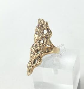 Ornate gold ring with abstract design.