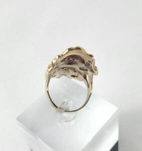 Gold ring with intricate, textured design.