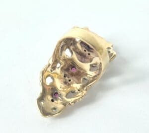 Gold ring with intricate skull design.