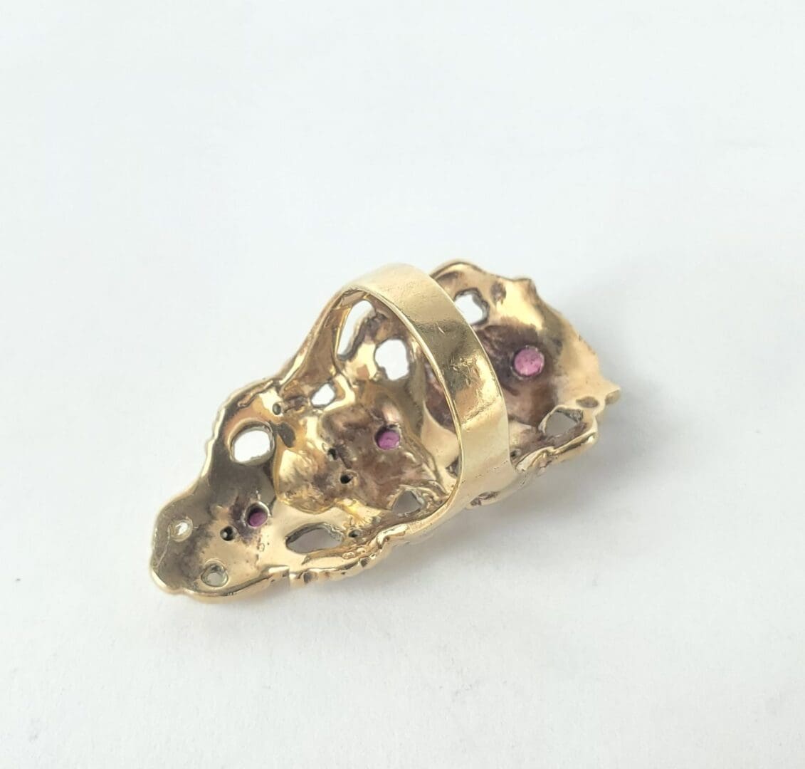 Gold ring with unique, textured design.