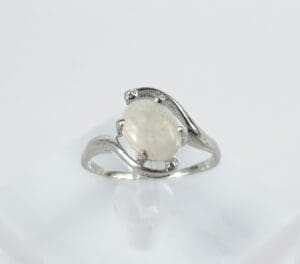 Silver ring with oval opal gemstone.