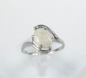 Silver ring with oval opal gemstone.
