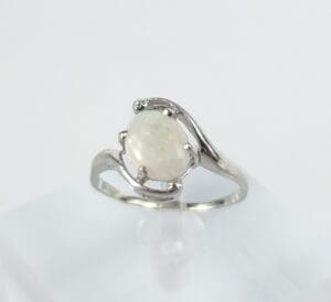 Silver ring with a white opal gemstone.